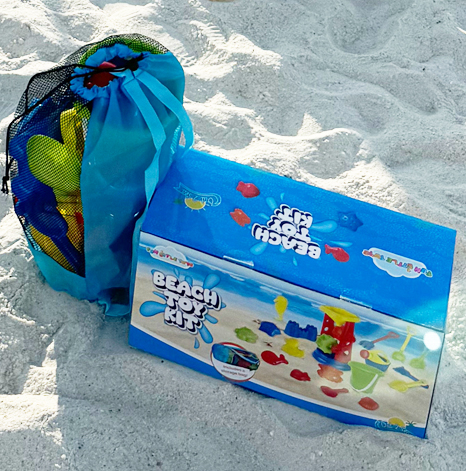 Home 9 Kids beach toy kit with mesh bag, buckets and moulds sitting on white sand